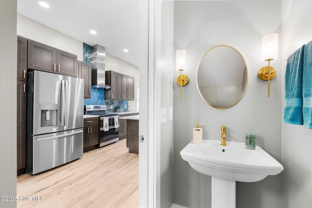 bathroom with recessed lighting, backsplash, and wood finished floors