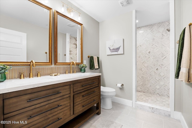 bathroom featuring double vanity, visible vents, a sink, and tile patterned floors