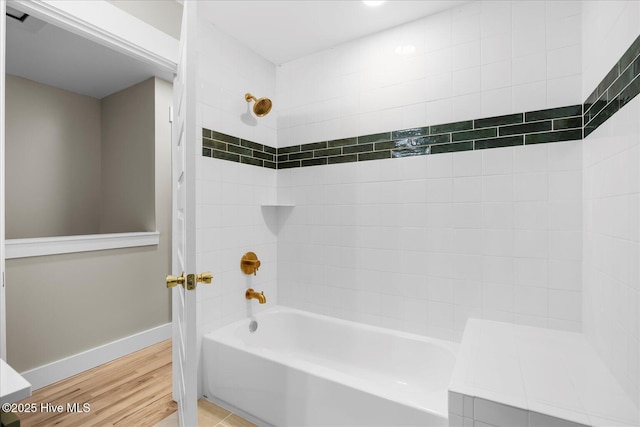 bathroom featuring shower / bath combination, baseboards, and wood finished floors