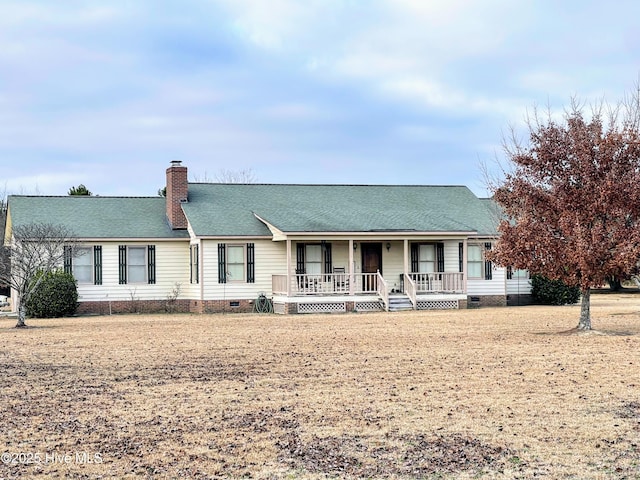 ranch-style home featuring crawl space, a chimney, a porch, and roof with shingles