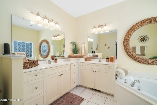 full bathroom featuring tile patterned floors, two vanities, a garden tub, and a sink