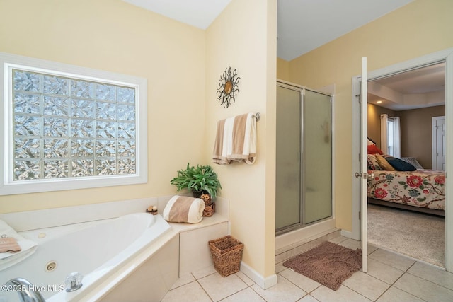 ensuite bathroom featuring a shower stall, a bath, tile patterned floors, and connected bathroom