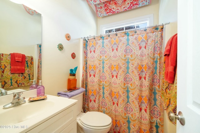 full bathroom with vanity, curtained shower, and toilet