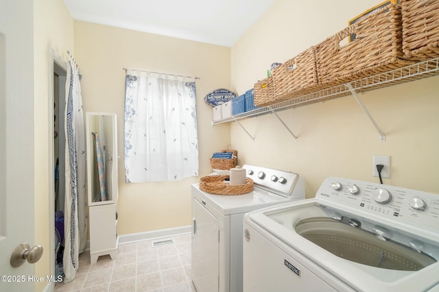 clothes washing area featuring visible vents, baseboards, laundry area, light tile patterned flooring, and washer and dryer