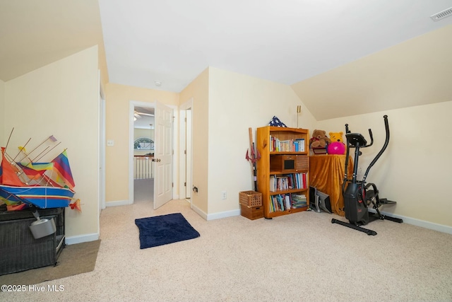 exercise room featuring visible vents, lofted ceiling, baseboards, and carpet flooring