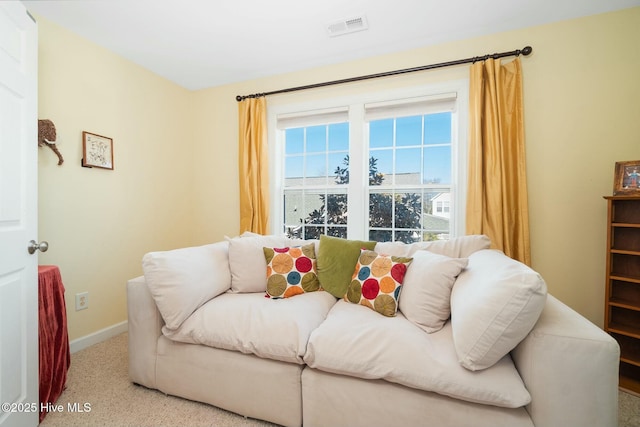 carpeted living room featuring visible vents and baseboards