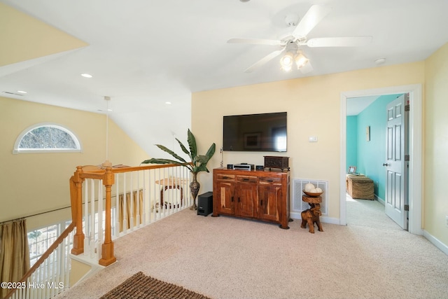 interior space with baseboards, visible vents, carpet floors, ceiling fan, and vaulted ceiling