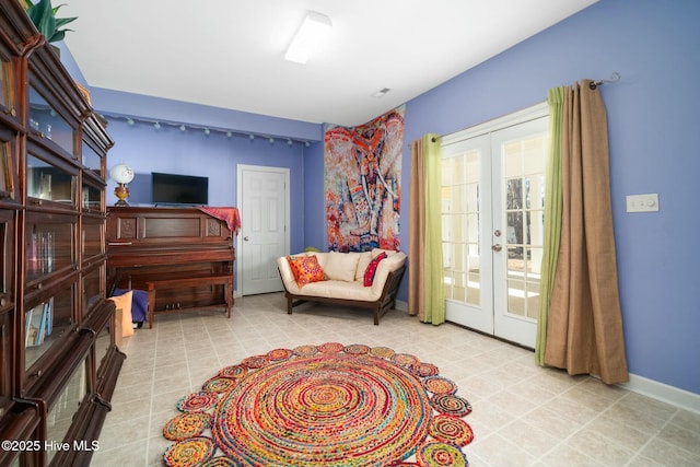 sitting room featuring french doors, baseboards, and visible vents