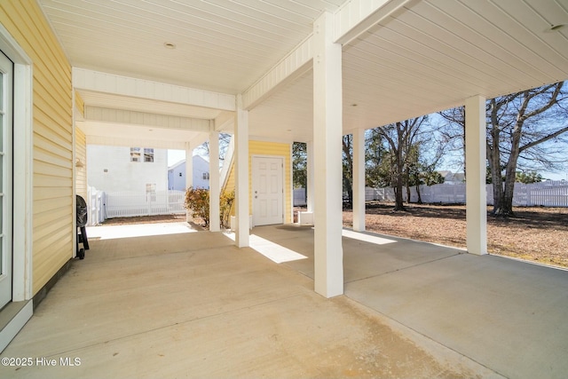 view of patio with a carport and fence