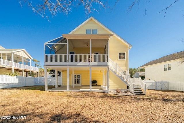 back of house with a fenced backyard, ceiling fan, stairs, french doors, and a patio area