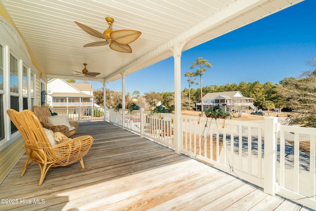 wooden deck with a ceiling fan