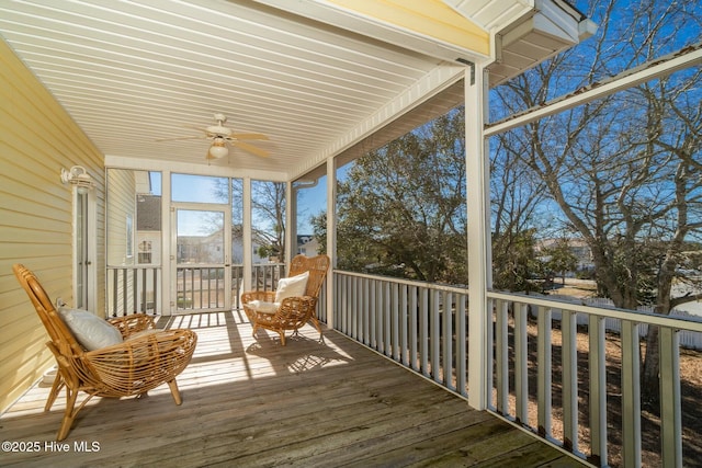 unfurnished sunroom with a ceiling fan