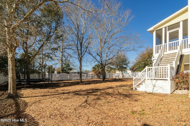 view of yard featuring a fenced backyard and a trampoline