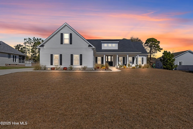 view of front of property with a front yard and covered porch