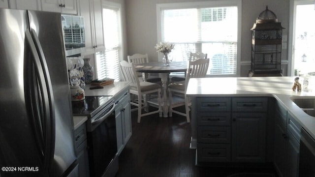 kitchen with stainless steel appliances, plenty of natural light, light countertops, and white cabinetry