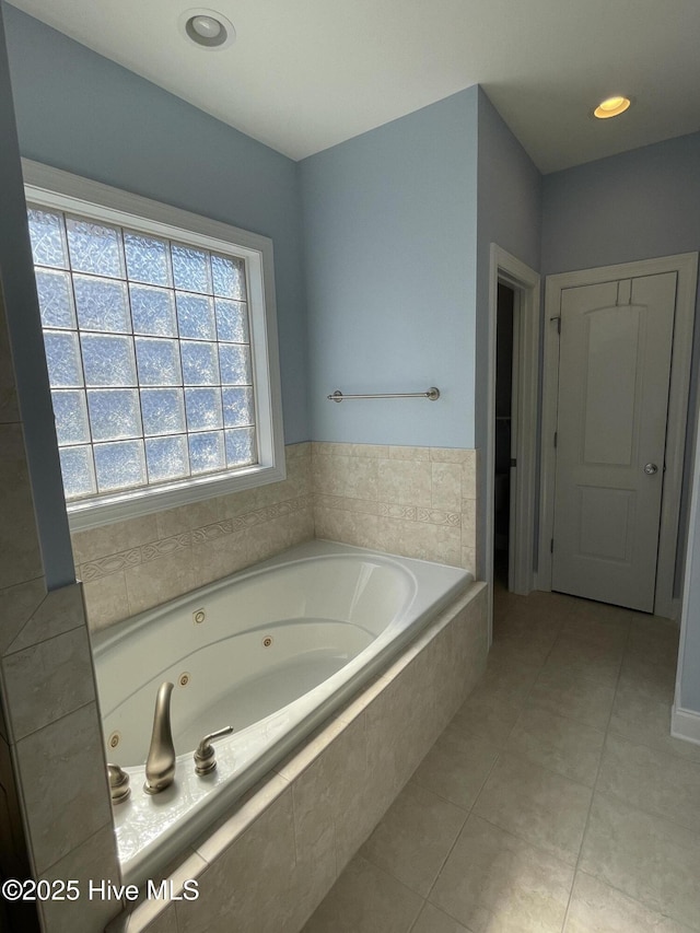 bathroom with a whirlpool tub and tile patterned floors