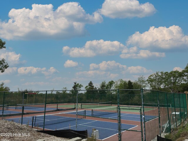 view of tennis court with fence