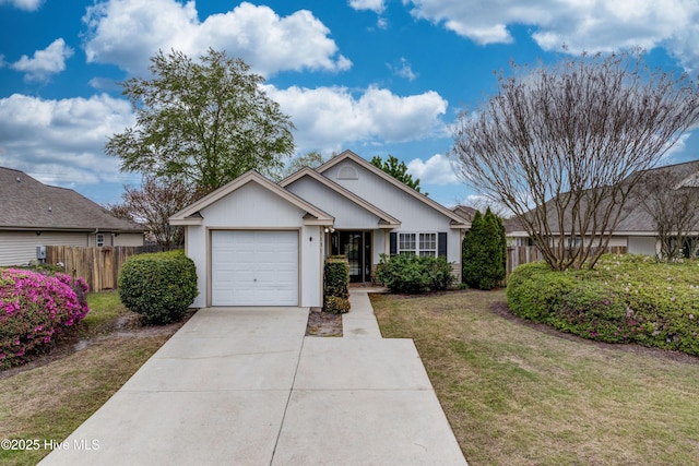view of front facade with an attached garage, fence, concrete driveway, and a front yard