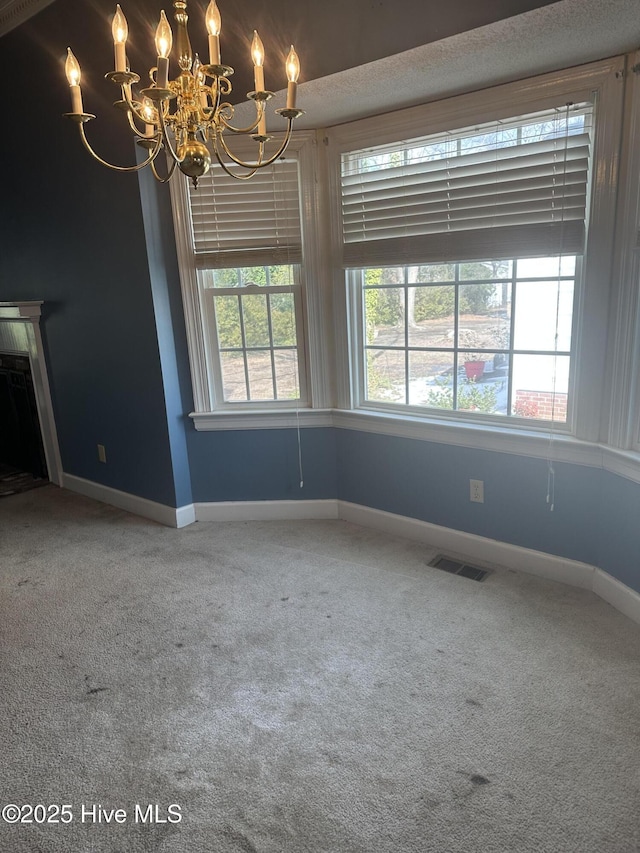 unfurnished dining area featuring carpet floors, baseboards, and visible vents