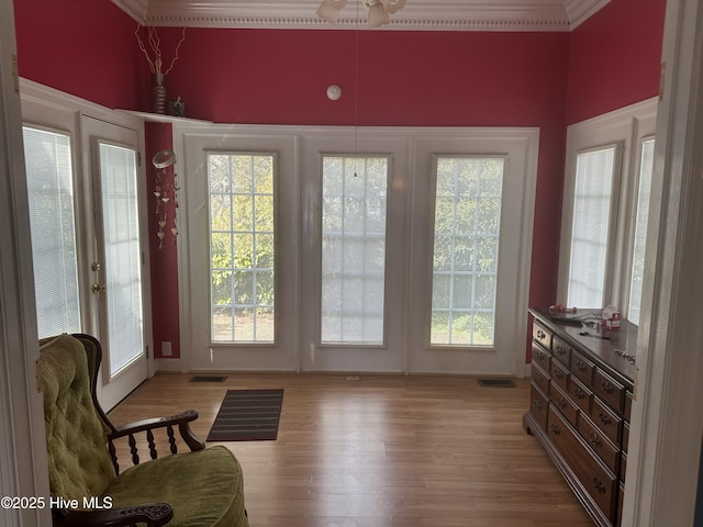 doorway featuring light wood-type flooring and visible vents