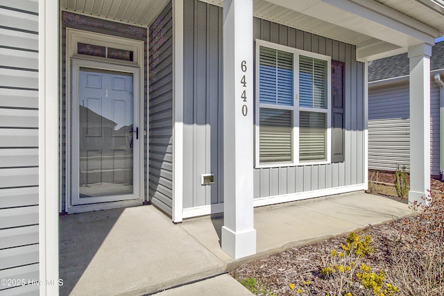 entrance to property with a porch and board and batten siding