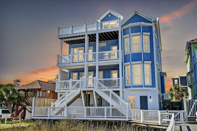 view of front of home with board and batten siding and stairway