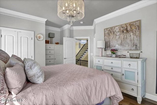 bedroom with crown molding, baseboards, dark wood finished floors, and a notable chandelier