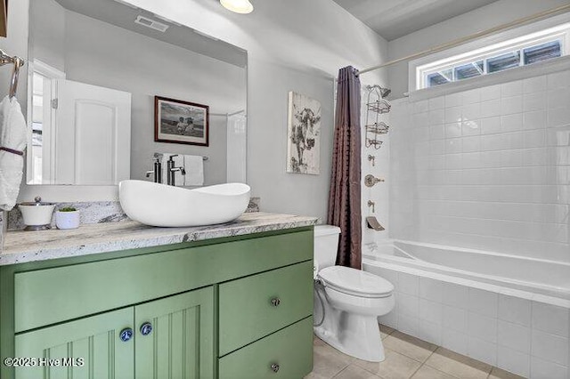 full bath with visible vents, toilet, tile patterned floors, tiled shower / bath, and vanity