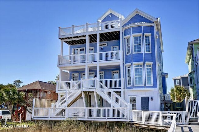 view of front of home featuring board and batten siding and stairway