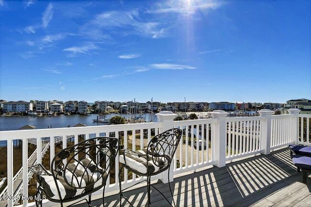 wooden deck featuring a water view