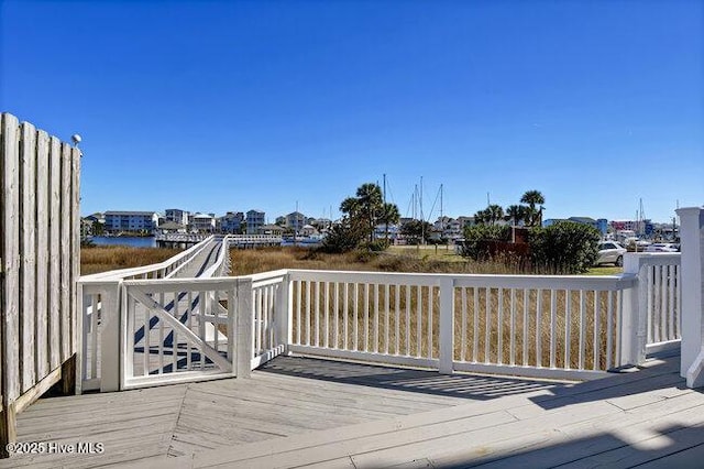 wooden terrace featuring a water view