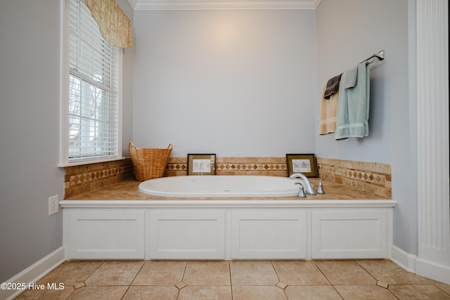 bathroom featuring tasteful backsplash, baseboards, ornamental molding, tile patterned flooring, and a bath