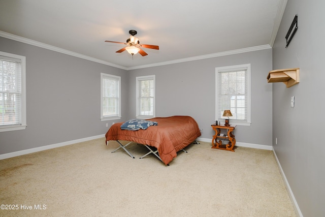 bedroom with ornamental molding, carpet, baseboards, and a ceiling fan