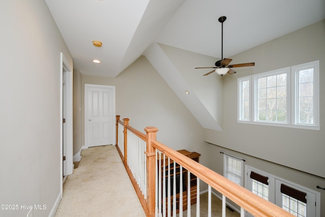 hallway with recessed lighting, baseboards, light colored carpet, and an upstairs landing