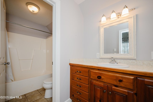 full bathroom featuring toilet, tile patterned floors, bathing tub / shower combination, and vanity