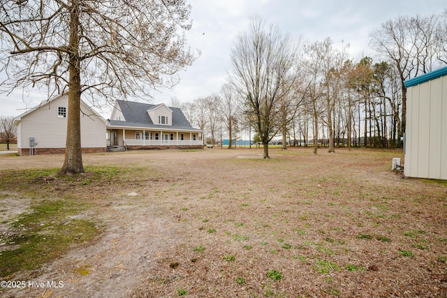 view of yard featuring covered porch