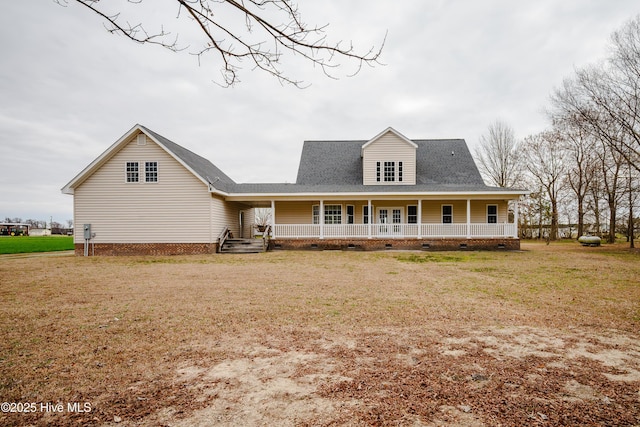 view of front of home with a porch, a front yard, and crawl space