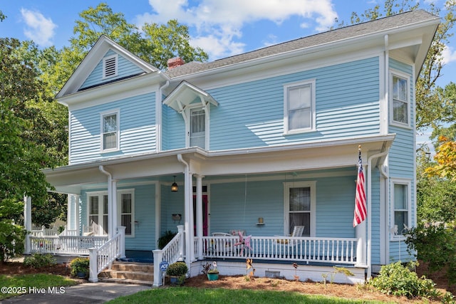 view of front of house featuring a porch and a chimney