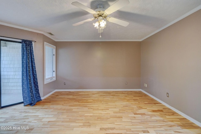 spare room with visible vents, a textured ceiling, crown molding, and light wood-style floors