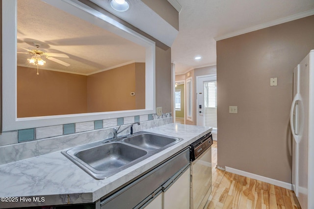 kitchen featuring white appliances, light wood-style flooring, ornamental molding, and a sink