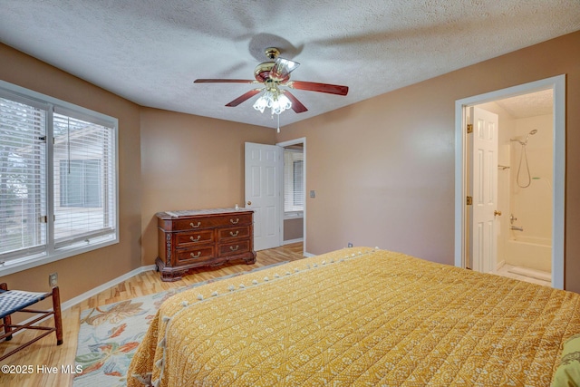 bedroom with light wood-type flooring, baseboards, a textured ceiling, and ceiling fan