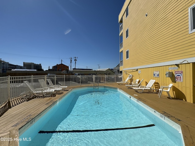 community pool featuring a deck and fence