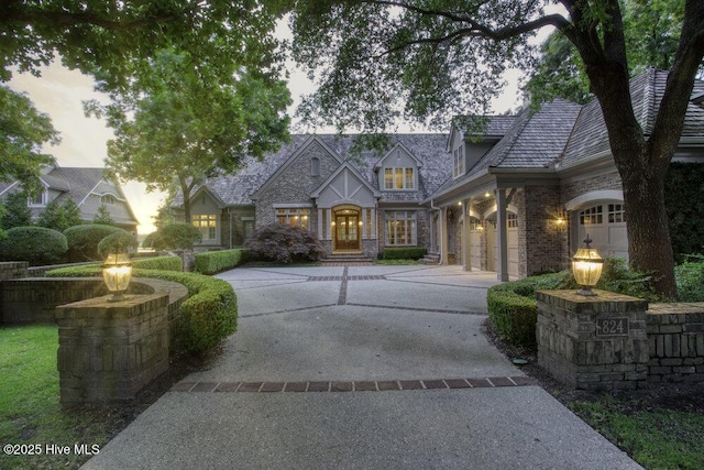 view of front of house featuring concrete driveway and brick siding