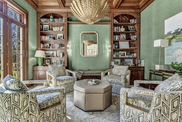 sitting room featuring built in shelves, coffered ceiling, crown molding, and beamed ceiling