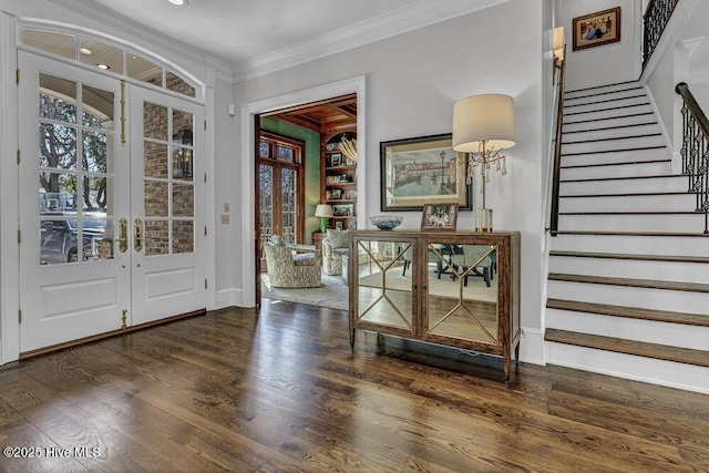 entrance foyer with french doors, dark wood-style flooring, stairway, ornamental molding, and baseboards