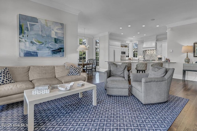 living room featuring baseboards, ornamental molding, dark wood finished floors, and a wealth of natural light