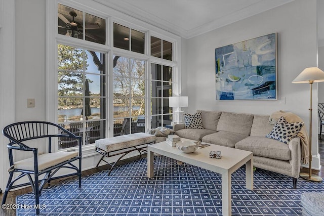 living room featuring a water view, crown molding, and wood finished floors