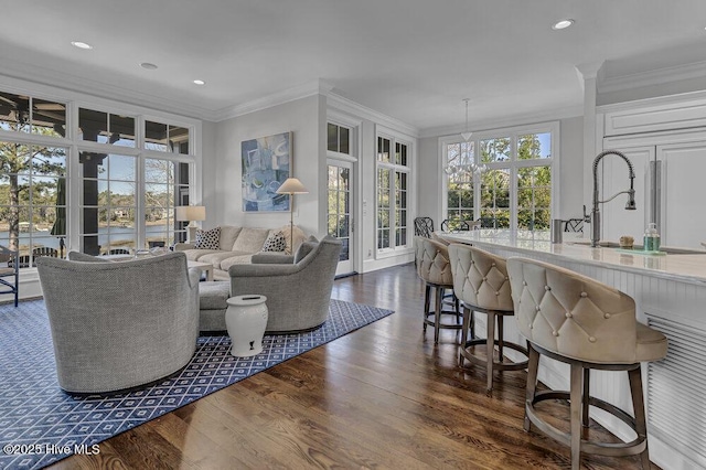 interior space featuring ornamental molding, dark wood-type flooring, and recessed lighting