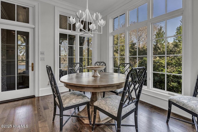 sunroom / solarium with an inviting chandelier