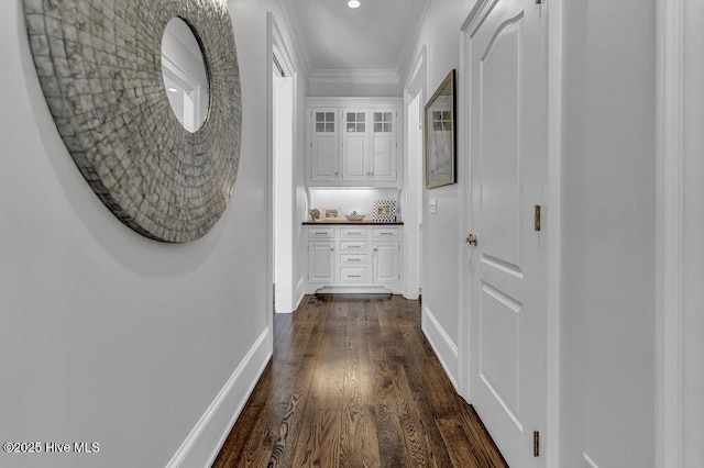 corridor featuring recessed lighting, dark wood-style flooring, and baseboards